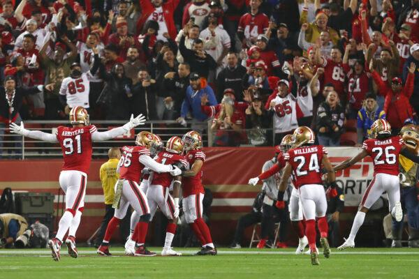 San Francisco 49ers free safety Jimmie Ward, third from bottom left, is congratulated by teammates after returning an interception for a touchdown against the Los Angeles Rams during the first half of an NFL football game in Santa Clara, Calif., on Nov. 15, 2021. (Jed Jacobsohn/AP Photo)
