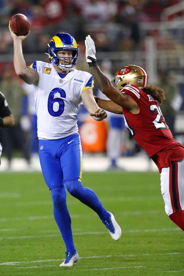 Los Angeles Rams punter Johnny Hekker (6) passes the ball against San Francisco 49ers' Talanoa Hufanga on a fake field goal attempt during the first half of an NFL football game in Santa Clara, Calif., on Nov. 15, 2021. (Jed Jacobsohn/AP Photo)