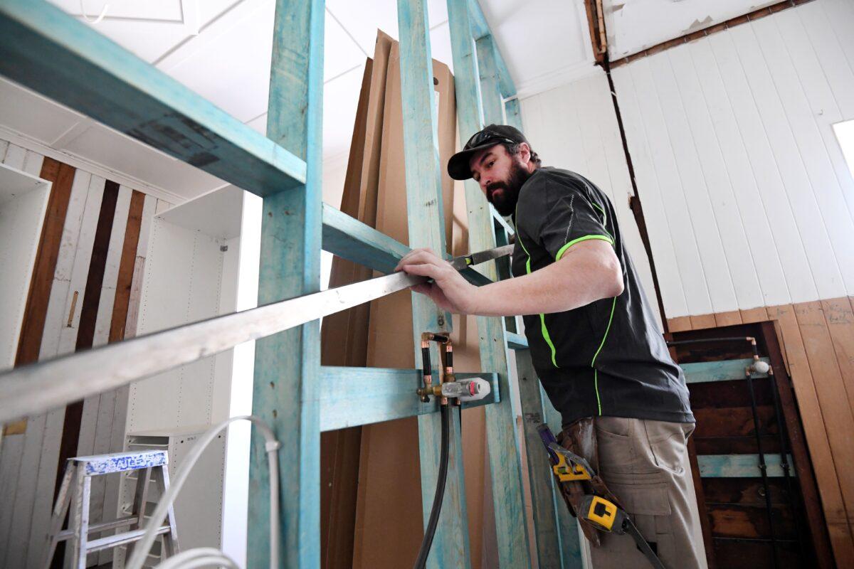 A carpenter is seen working on a house renovation in Brisbane, Australia, on June 4, 2020. (AAP Image/Dan Peled)
