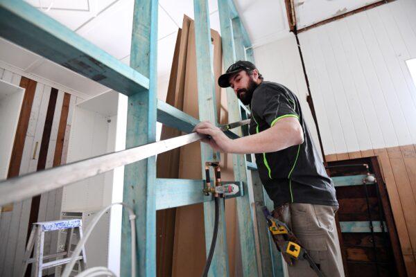 A carpenter is seen working on a house renovation in Brisbane, Australia, June 4, 2020. (AAP Image/Dan Peled)