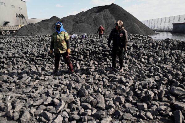 Workers sort coal near a coal mine in Datong, China's northern Shanxi Province on Nov. 3, 2021. (Noel Celis/AFP via Getty Images)