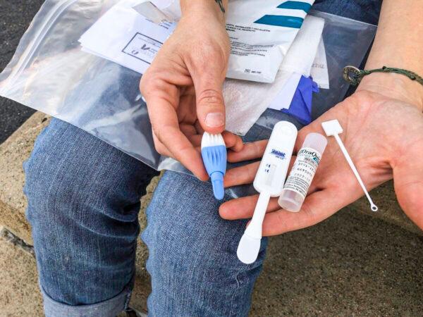A person holds an HIV testing kit in Charleston, W.Va., on March 9, 2021. (John Raby/AP Photo)