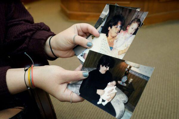 Lindsey Kirk shows childhood photographs of herself and her late mother Kim Kirk Cox, in New Albany, Miss., on Nov. 13, 2021. (Rogelio V. Solis/AP Photo)