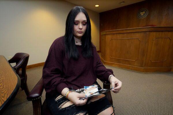 Lindsey Kirk looks at childhood photographs of herself and her late mother Kim Kirk Cox, in New Albany, Miss., on Nov. 13, 2021. (Rogelio V. Solis/AP Photo)