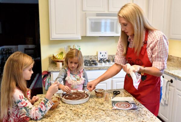 Amelia Stansell helps her daughters ice a batch of brownies. (Randy Litzinger)