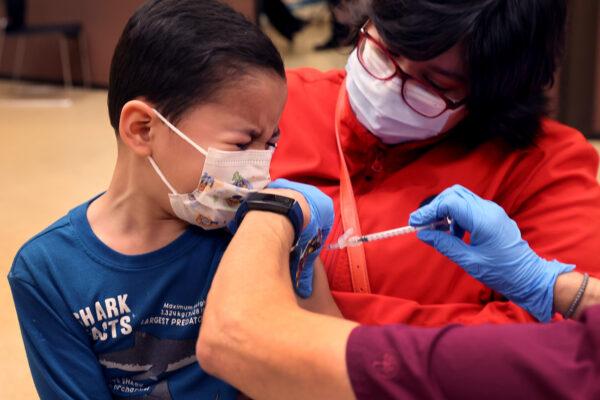 First-grade student, 6-year-old Leonel Campos, receives a COVID-19 vaccine at Arturo Velasquez Institute in Chicago, on Nov. 12, 2021. ( Scott Olson/Getty Images)