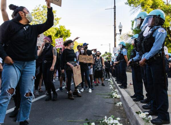 Protesters chant and wave signs at the CPD, after George Floyd died in Minneapolis police custody, during a protest in Chicago, Ill., on June 6, 2020. (Natasha Moustache/Getty Images)