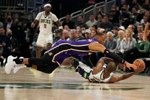 Milwaukee Bucks' Khris Middleton and Los Angeles Lakers' Russell Westbrook battle for a loose ball during the first half of an NBA basketball game in Milwaukee on Nov. 17, 2021. (Morry Gash/AP Photo)
