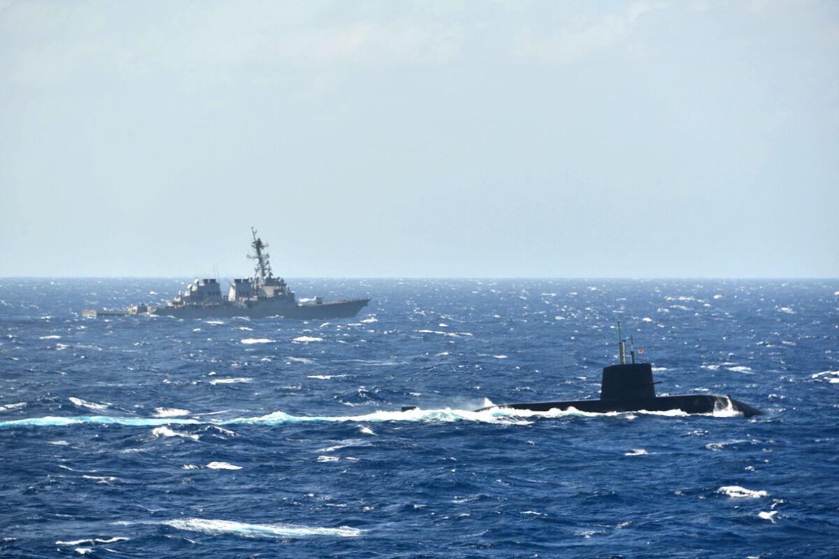 Japan’s Maritime Self-Defense Force submarine and a U.S. Navy destroyer are pictured in their first joint anti-submarine drill in the South China Sea on Nov. 16, 2021. (The Japanese Maritime Self-Defense Force)
