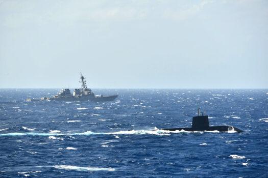 Japan’s Maritime Self-Defense Force submarine and a U.S. Navy destroyer pictured in their first joint anti-submarine drill in the South China Sea, on Nov. 16, 2021. (Courtesy of The Japanese Maritime Self-Defense Force)