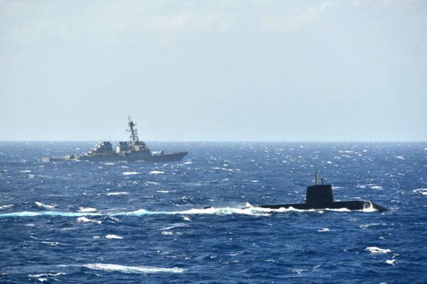 Japan’s Maritime Self-Defense Force submarine and a U.S. Navy destroyer pictured in a joint anti-submarine drill in the South China Sea in November 2021. (The Japanese Maritime Self-Defense Force)