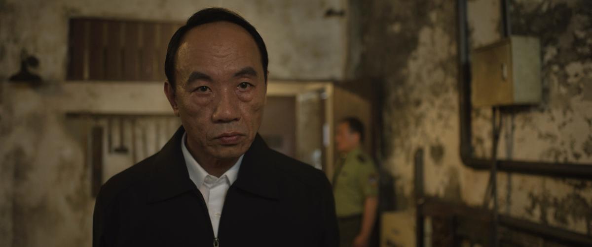  CCP Secretary Yang (Tzu-Chiang Wang) supervises the interrogation of a Falun Gong practitioner, in a scene from "Unsilenced." (Courtesy of Flying Cloud Productions)