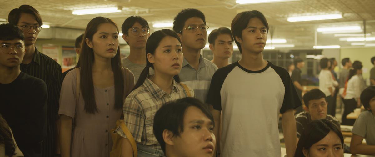 Students watching the devastating news that Falun Gong, a practice to improve the mind and body, is being threatened by China's communist regime, in a scene from "Unsilenced." (Courtesy of Flying Cloud Productions)