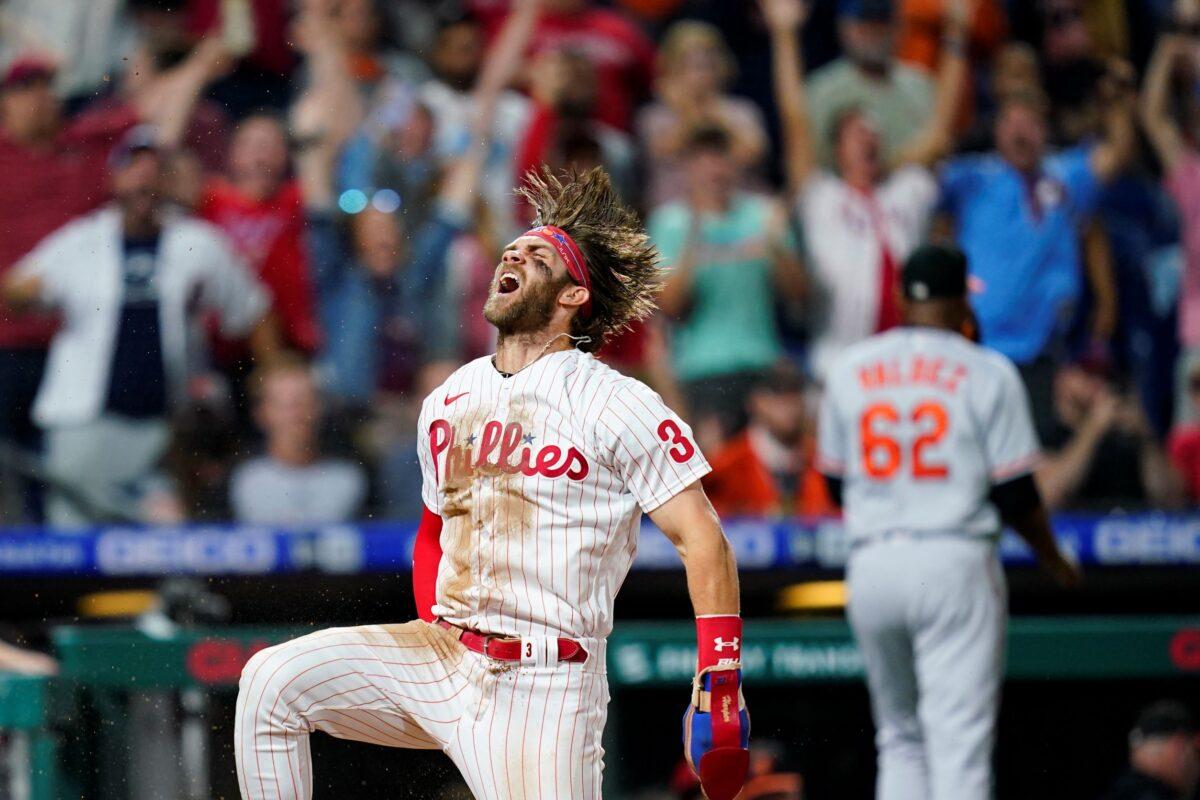 Philadelphia Phillies' Bryce Harper celebrates after scoring the game-winning run on a two-run triple by J.T. Realmuto during the 10th inning of an interleague baseball game against the Baltimore Orioles in Philadelphia, on Sept. 21, 2021. (Matt Slocum/AP Photo)
