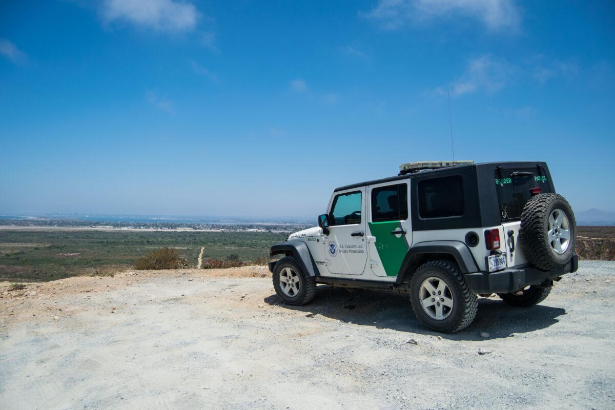 A Border Patrol jeep overlooks the end of the U.S.-Mexico border barrier at the Pacific Ocean in San Diego. (Joshua Philipp/The Epoch Times)