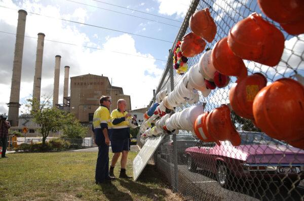 Workers hang their hard hats on the fence outside the Hazelwood Power Station on the final day of operation in Hazelwood, Australia, on March 31, 2017. (Scott Barbour/Getty Images)