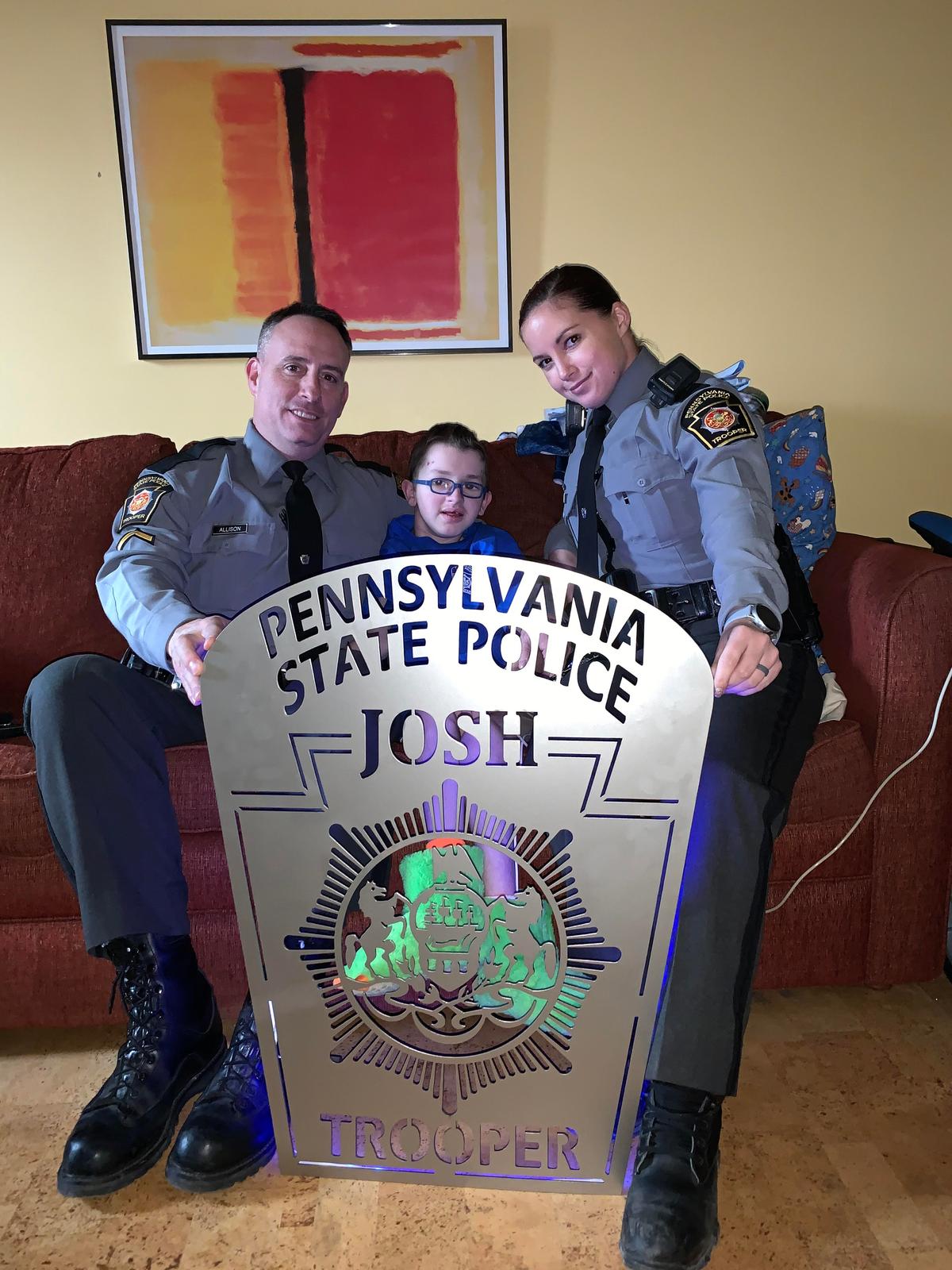 Josh with the officers from Pennsylvania State Police during his spinal surgery in Pittsburg. Trooper Allison (L) is still in touch with Josh, and he even visited Josh after surgery and rubbed his legs and talked with him for hours to help stop his pain and muscle spasms. (Courtesy of <a href="https://www.facebook.com/rebecca.bourassa.3">Rebecca Bourassa</a>)