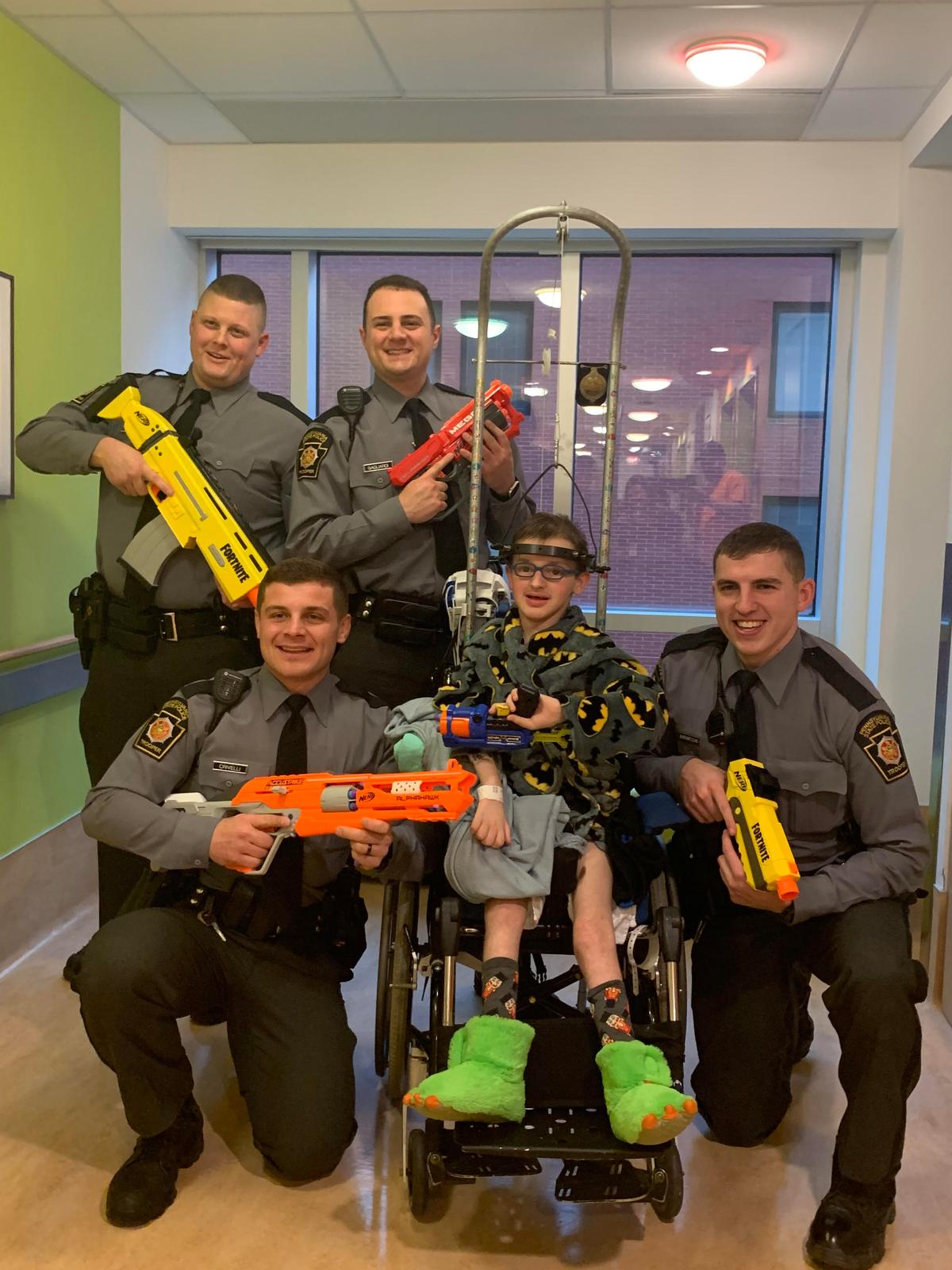 Josh with police officers when he was in the children's hospital in Pittsburgh for his scoliosis surgery. The officers often use to come and spend quality fun time with him. (Courtesy of <a href="https://www.facebook.com/rebecca.bourassa.3">Rebecca Bourassa</a>)
