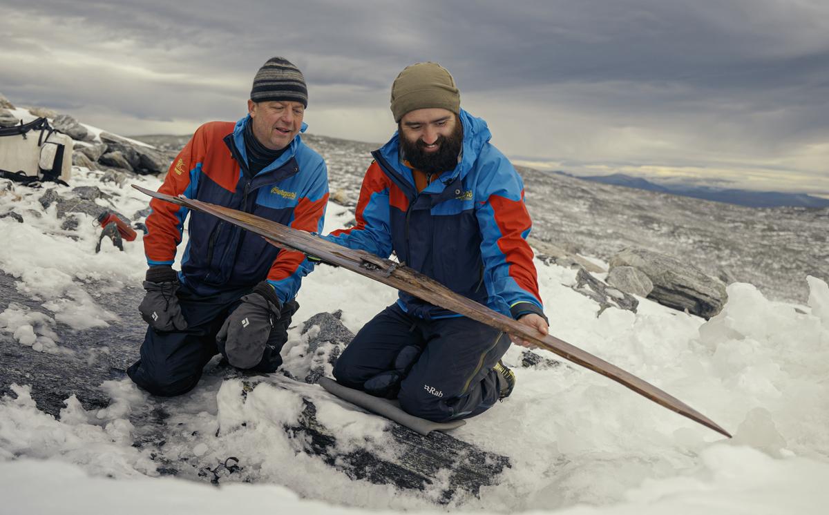 Espen Finstad (L), co-director of Secrets of the Ice, and Julian Post-Melbye, from the Museum of Cultural History, admiring the ski. (Courtesy of <a href="https://secretsoftheice.com/">Andreas Christoffer Nilsson, secretsoftheice.com</a>)