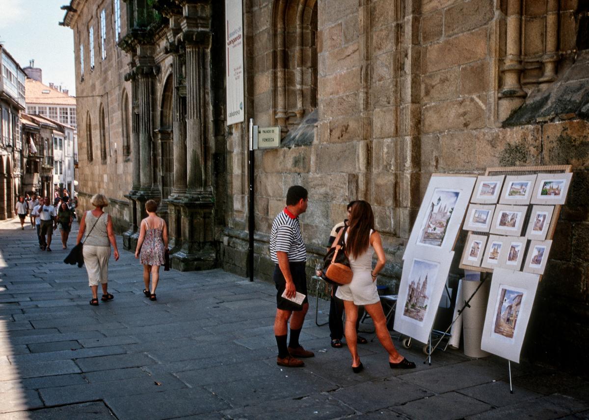 Tourists strolling through Santiago de Compostela’s Zona Vella or Old Town will encounter artists selling their works. (Copyright Fred J. Eckert)