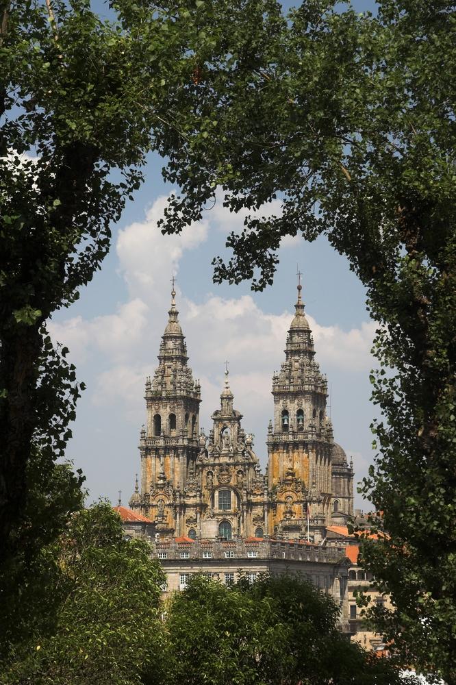 Cathedral of Santiago de Compostela seen through trees. (Juha-Pekka Kervinen/Shutterstock)