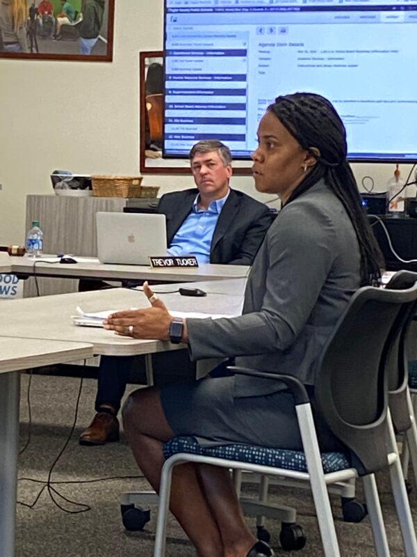 LaShakia Moore, director of teaching and learning at Flagler County School District, provides policy information to the school board members regarding procedures for challenged materials while FCSB Chair Trevor Tucker looks on at a workshop in Bunnell, Fla., on Nov. 16, 2021. (Patricia Tolson/The Epoch Times)