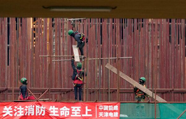 Vietnamese workers at the construction site of the first Chinese car tire factory in Europe near the northern Serbian town of Zrenjanin, 50 kilometers north of Belgrade, Serbia, on Nov. 18, 2021. (Darko Vojinovic/AP Photo)