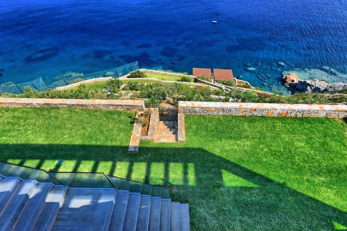 The skillfully terraced and landscaped gardens of the villa lead to the private beach and picnic pavilions below. (Pantelis Mathioudakis)