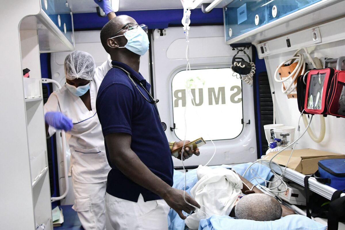 An emergency doctor and a nurse tend to a patient in an ambulance of the Emergency Medical Service (SAMU) during a transfer in Ouakam, a suburb of Dakar, on Aug. 24, 2021. (Seyllou/AFP via Getty Images)