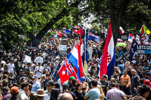 Tens of thousands of protesters with placards and flags at Flagstaff Gardens in Melbourne, Australia, on Nov. 20, 2021. (Darrian Traynor/Getty Images)