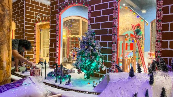The window display on the Gingerbread House is almost complete at Fairmont San Francisco on Nov. 18, 2021. (Ilene Eng/The Epoch Times)