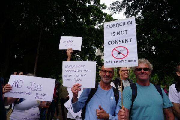 People holding signs saying “Coercion Is Not Consent,” “No Jab,” “Mandatory Vaccinations are a Violation against Human Rights” in Sydney, Australia, on Nov. 20, 2021. (Nina Nguyen/ Epoch Times)