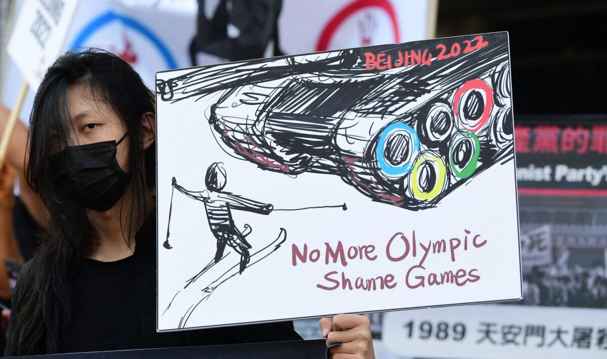 A woman holds a sign, calling for a boycott of the 2022 Beijing Winter Olympics due to concerns over China's human rights record, as activists rally in front of the Chinese Consulate in Los Angeles, Calif., on Nov. 3, 2021. (Frederic J. Brown/AFP via Getty Images)