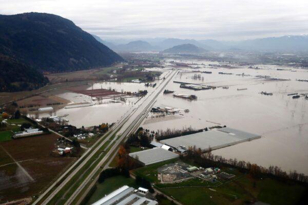 Aerial photo shows flooded farms along the Trans-Canada Highway in Abbotsford, B.C., on Nov. 22, 2021. (The Canadian Press/Darryl Dyck)