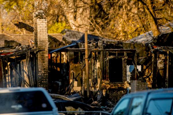 The shell of the home, seen on Tuesday morning, Nov. 23, 2021, where an explosion and house fire occurred late Monday, Nov. 22 in the 3900 block of Hogarth Avenue on Flint's west side, Mich. (Jake May | MLive.com via AP)