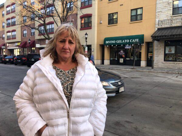 Waukesha local Sue Beedle on Nov. 22, 2021, stands on the block where the Christmas parade attack happened the day before. (Cara Ding/The Epoch Times)