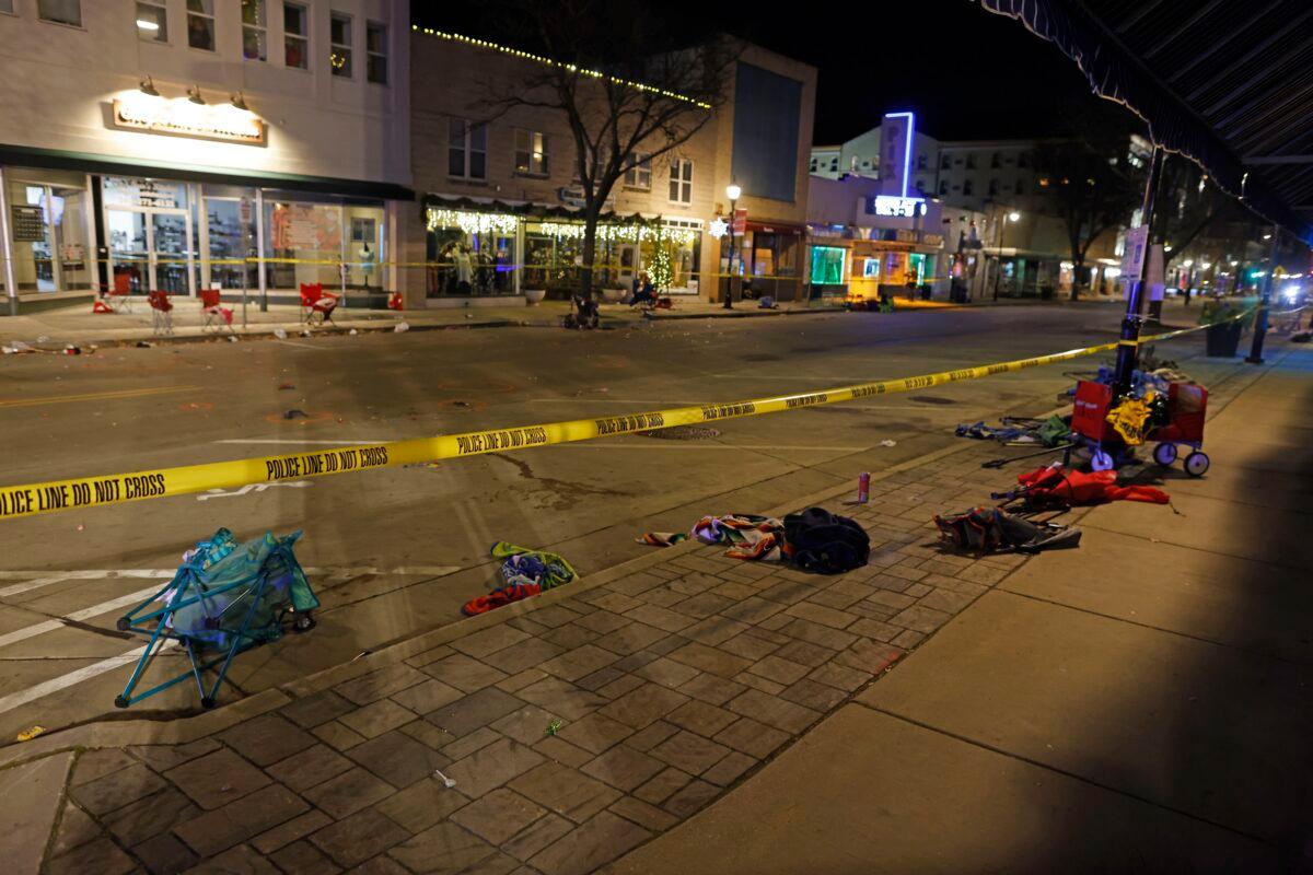 Police tape cordons off a street in Waukesha, Wis., after an SUV plowed into a Christmas parade, hitting multiple people on Nov. 21, 2021. (Jeffrey Phelps/AP Photo)