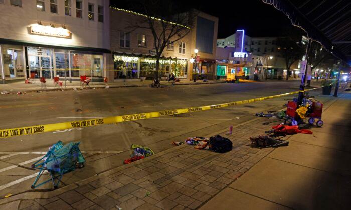 Police tape cordons off a street in Waukesha, Wis., after an SUV plowed into a Christmas parade hitting multiple people on Nov. 21, 2021. (Jeffrey Phelps/AP Photo)