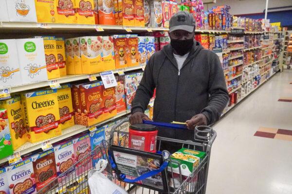 Edward Garrett searches for groceries for Thanksgiving dinner at the Food City grocery store in Rossville, Ga., on Nov. 23, 2021. (Jackson Elliott/The Epoch Times)
