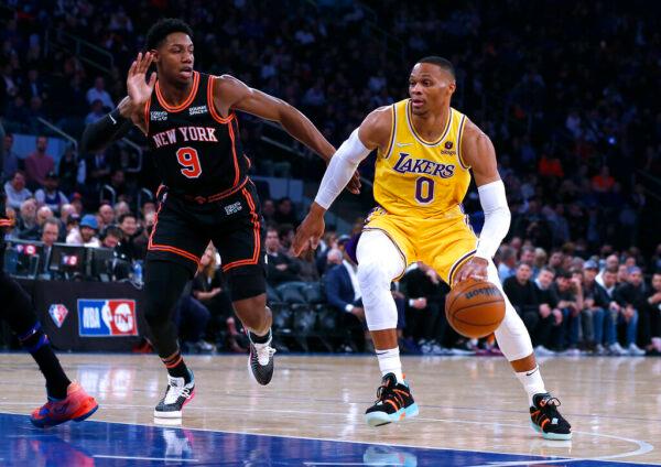 Los Angeles Lakers guard Russell Westbrook (0) drives against New York Knicks guard RJ Barrett (9) during the first half of an NBA basketball game in New York, on Nov. 23, 2021. (Jim McIsaac/AP Photo)