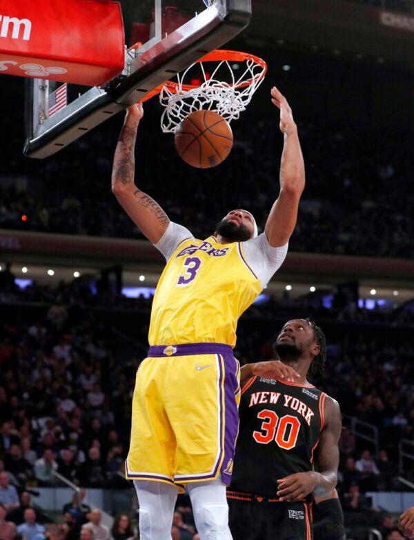 Los Angeles Lakers forward Anthony Davis (3) dunks in front of New York Knicks forward Julius Randle (30) during the first half of an NBA basketball game in New York, on Nov. 23, 2021. (Jim McIsaac/AP Photo)