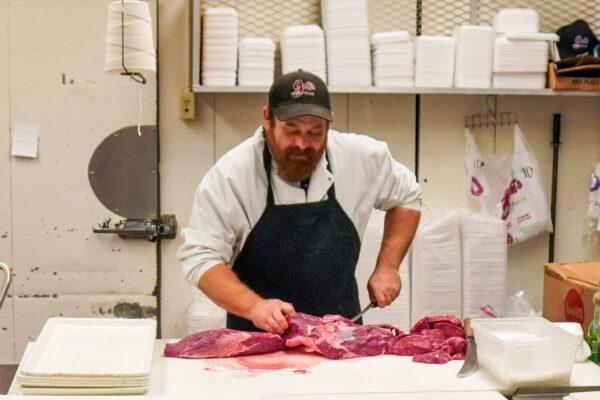 Manager Jed Matthews says the only thing short in his department this Thanksgiving was "turkey gizzards sold separately" at Jeff's Marketplace in Lexington, Mich., on Nov. 23, 2021. (Steven Kovac/The Epoch Times)