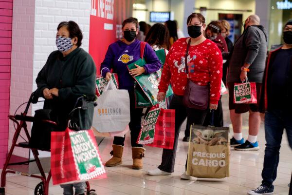 Black Friday shoppers wearing masks wait in line to enter a store at the Glendale Galleria in Glendale, Calif., on Nov. 27, 2020. (Ringo H.W. Chiu/AP Photo)