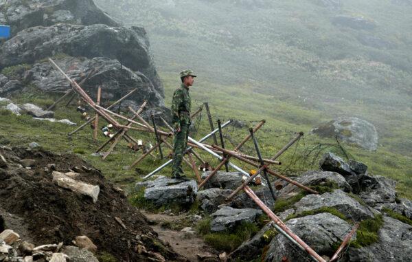 A Chinese soldier stands guard on the Chinese side of the ancient Nathu La border crossing between India and China on July 10, 2018. (Dipendu Dutta/AFP via Getty Images)