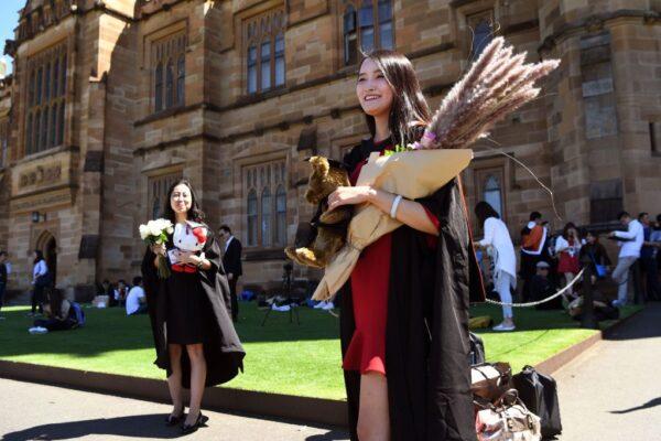 Student poses for family photos after graduating from Sydney University on Oct. 12, 2017. (William West/AFP via Getty Images)