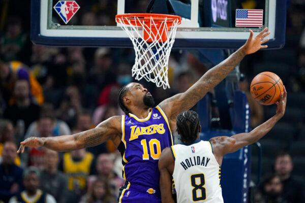 Indiana Pacers' Justin Holiday (8) shoots against Los Angeles Lakers' DeAndre Jordan (10) during the first half of an NBA basketball game in Indianapolis, on Nov. 24, 2021. (Darron Cummings/AP Photo)