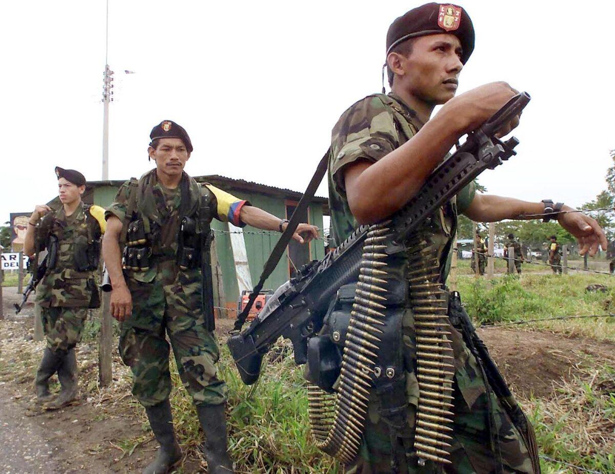 In this file photo taken in February 2001, Revolutionary Armed Forces of Colombia (FARC) guerrillas guard the location of talks between Manuel Marulanda, Marxist rebel chief of the FARC, and then-Colombian President Andres Pastrana. (Luis Acosta/AFP via Getty Images)