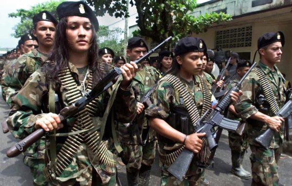 In this file photo taken in 2001, guerrillas of the Marxist Revolutionary Armed Forces of Colombia march in a military parade in San Vicente, Colombia. (Luis Acosta/AFP via Getty Images)