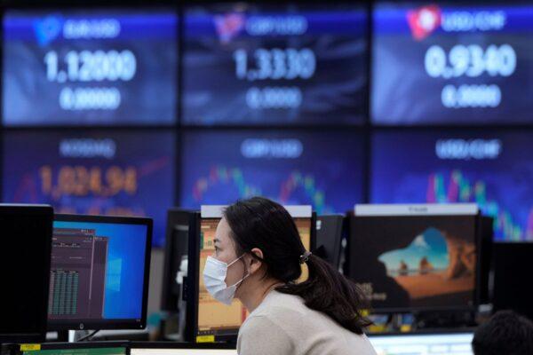 A currency trader watches monitors at the foreign exchange dealing room of the KEB Hana Bank headquarters in Seoul, South Korea on Nov. 25, 2021. (Ahn Young-joon/AP Photo)