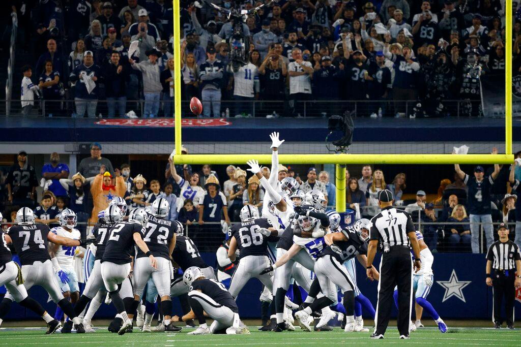 Fans look on as Las Vegas Raiders' Daniel Carlson (2) kicks a game-winning field goal in overtime of an NFL football game against the Dallas Cowboys in Arlington, Texas, on Nov. 25, 2021. (Michael Ainsworth/AP Photo)